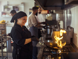 Close up of a chef Flambéing in a restaurant kitchen