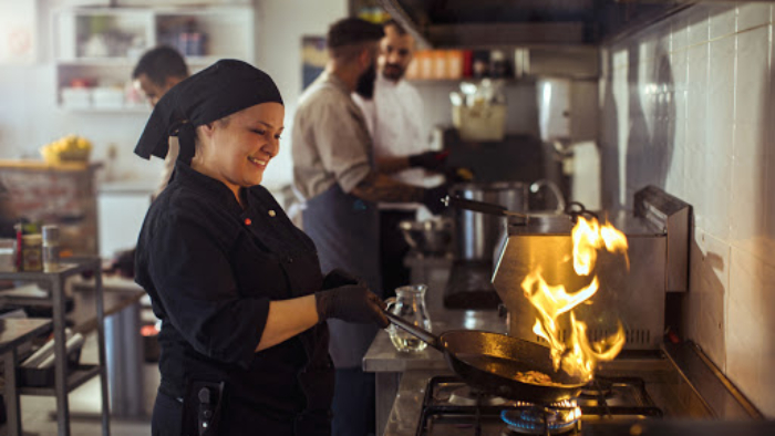 Close up of a chef Flambéing in a restaurant kitchen