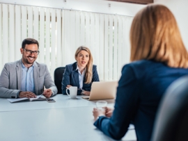 Business - young woman sitting in job interview.