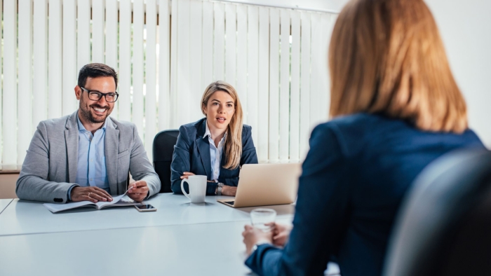 Business - young woman sitting in job interview.